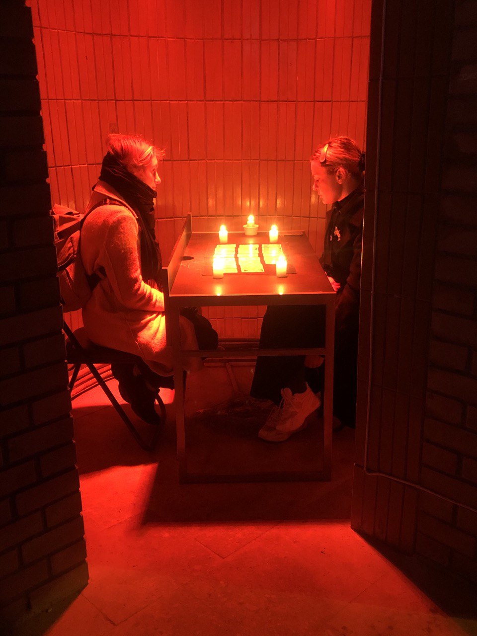Tanya Fishmann, Cards on the Table, 2021, the artist reading Tarot cards with a participant during the performance at Dzherelo Gallery