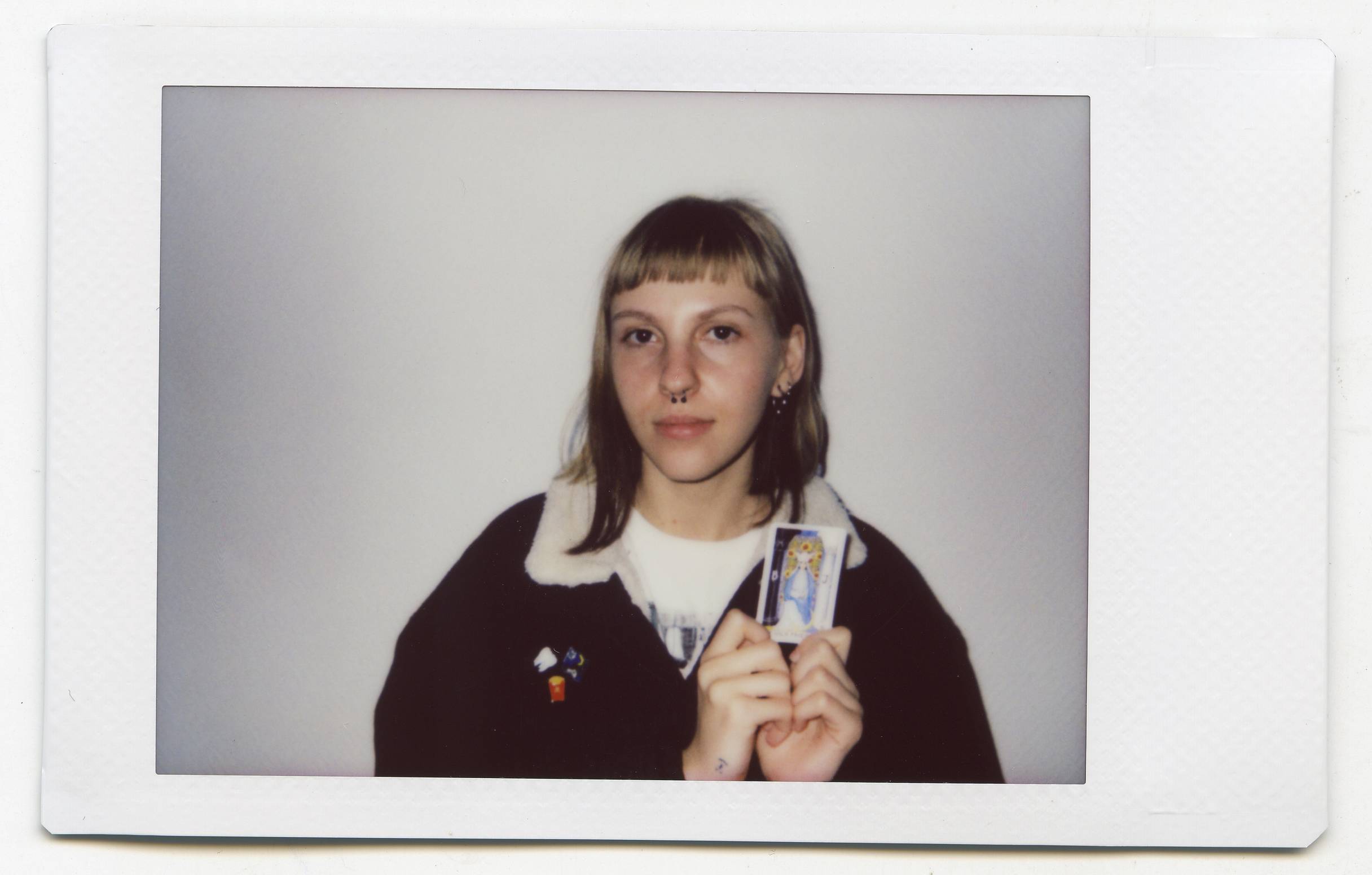 Tanya Fishmann, Liberation, 2021, instant analog portrait of a participant holding their Major Arcana Tarot card after the performance encounter