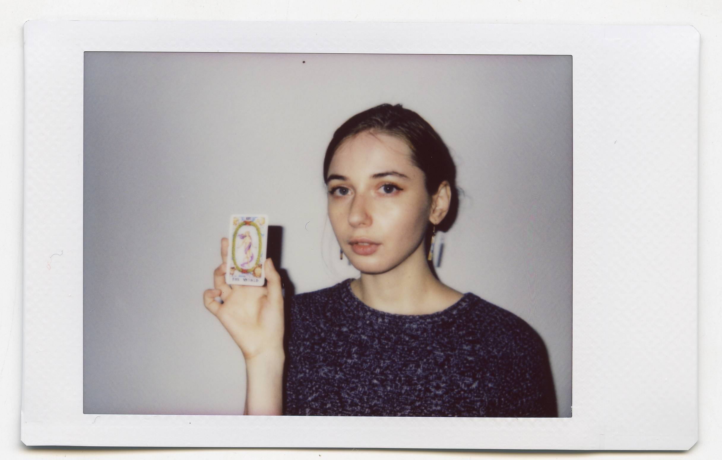 Tanya Fishmann, Liberation, 2021, instant analog portrait of a participant holding their Major Arcana Tarot card after the performance encounter