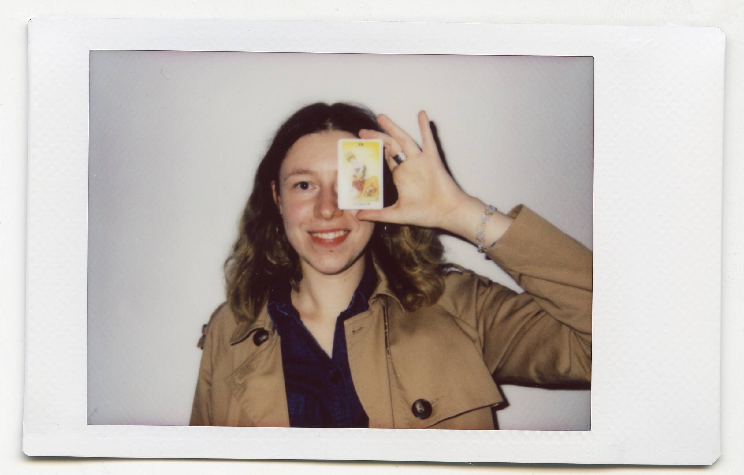 Tanya Fishmann, Liberation, 2021, instant analog portrait of a participant holding their Major Arcana Tarot card after the performance encounter
