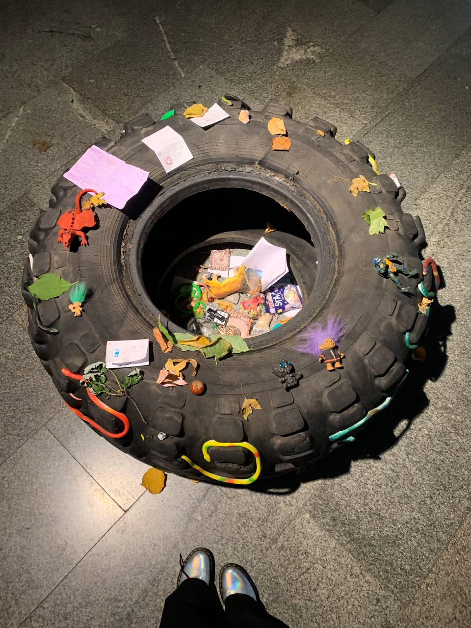 Tanya Fishmann, Ritual, 2021, installation of a large truck tire filled with children's toys and handmade symbolic objects, childhood mythology and protection ritual